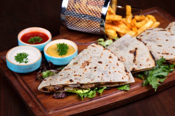 close up picture of two mexican quesadillas and salad
