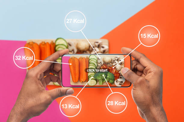 istock Afro man holding cellphone with application for counting calories 1178903398