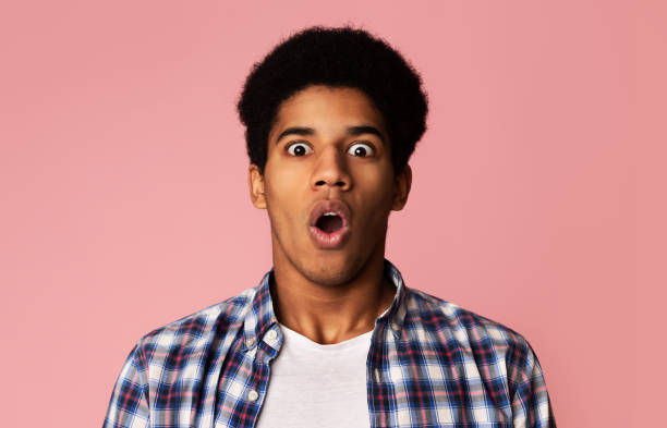Surprised african-american guy opened mouth in amazement