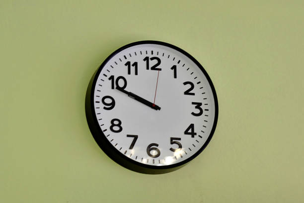 istock clock on the wall in the office 1178906878