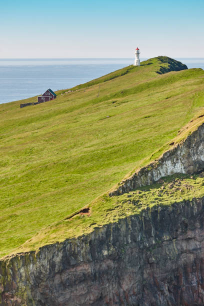 istock Mykines lighthouse and cliffs on Faroe islands. Hiking landmark 1178908049