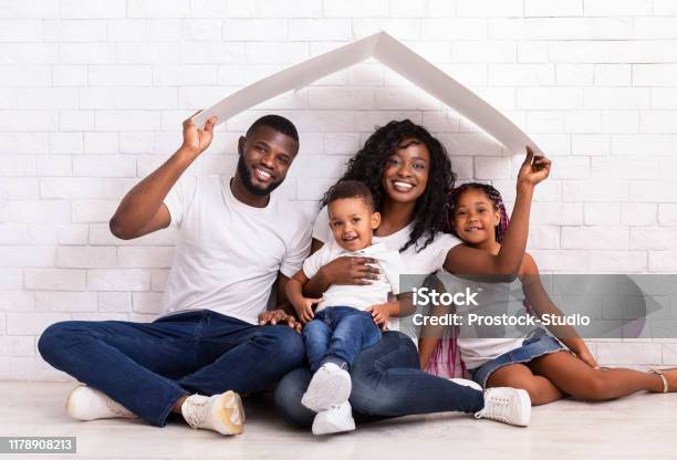 Beautiful Black Family Holding Cardboard Roof Dreaming Of New Home Stock Photo - Download Image Now