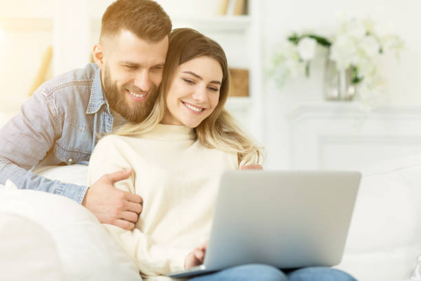 istock Online video-call. Happy couple using laptop, free space 1178908458