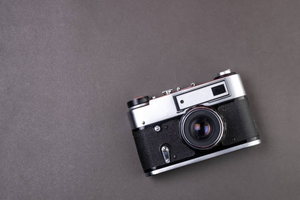 istock old film camera silver color on black background paper 1178908549