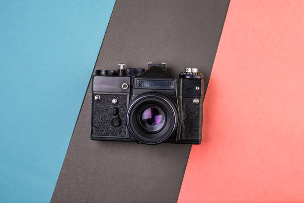 istock old large black film camera on tri-color paper 1178908569