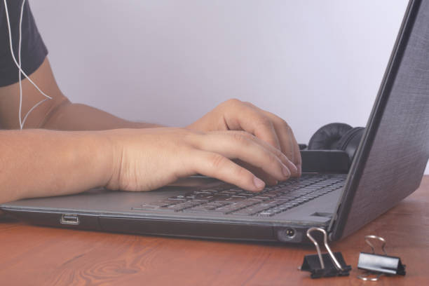 istock freelancer working on a laptop and chatting in his spare time on social networks,typing on the keyboard 1178908574