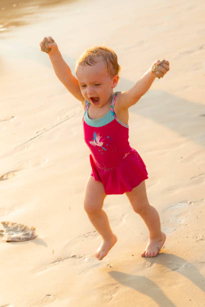 istock A little girl runs along the beach 1178909814