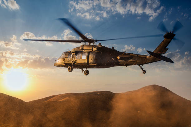 istock Military Helicopter flying against sunset 1178909972