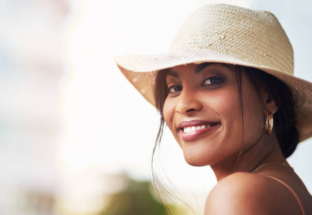 Closeup portrait of an attractive young woman feeling cheerful while out and about in the cit