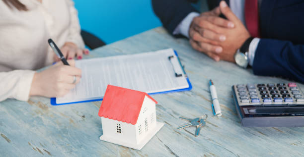 istock woman signs a mortgage contract 1178910854