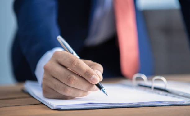 istock businessman signs documents in his office 1178910857
