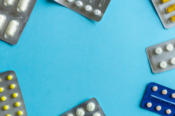 istock Packs of pills (drugs) on a colored background. Minimal concept. 1178911147