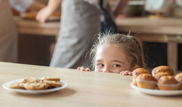 istock Cute little girl looking with joy at sweets 1178912771