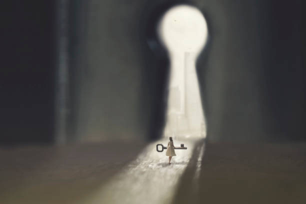 small woman carries the key to open the lock small woman carries the key to open the lock keyhole photos stock pictures, royalty-free photos & images