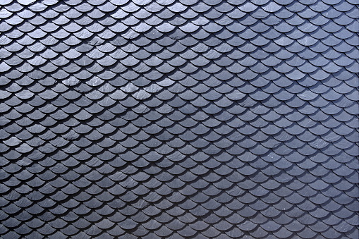 Aged slate roof tiles in close-up