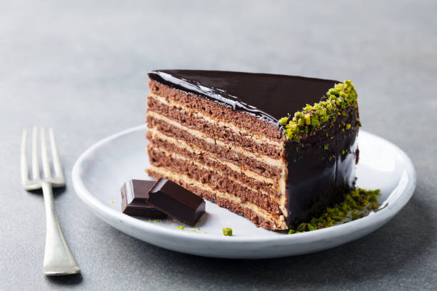 istock Chocolate cake on a white plate. Grey stone background. Close up. 1178916534