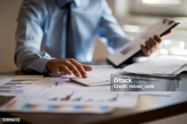 Business Accounting Concept Business Man Using Calculator With Computer Laptop Budget And Loan Paper In Office Stock Photo - Download Image Now