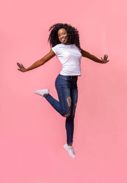 istock Playful african girl having fun over pink studio background 1178917485