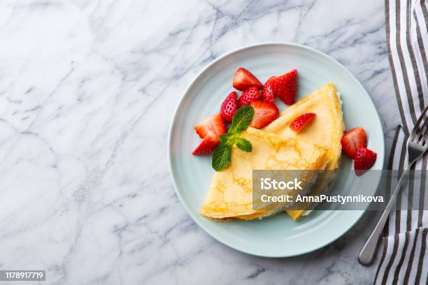 Crepes Thin Pancakes With Cream Cheese Ricotta And Fresh Strawberries Marble Background Top View Copy Space Stock Photo - Download Image Now