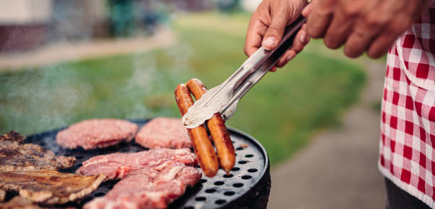 istock Men wearing apron barbecuing chicken meat 1178917753