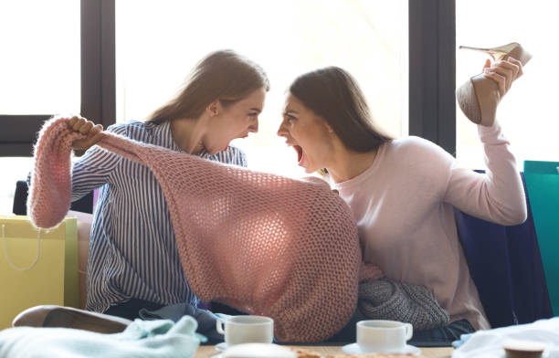 istock Two young girls arguing about sweater they have bought 1178918236