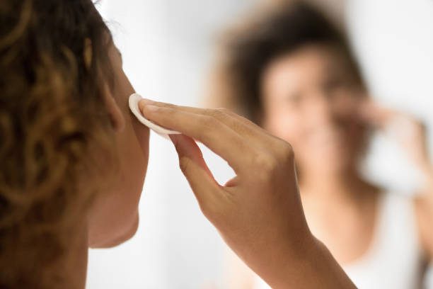 istock Unrecognizable Girl Removing Makeup Looking At Reflection In Mirror Indoor 1178918295