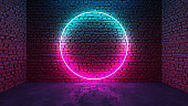 Circle shaped glowing neon frame on brick wall in dark room