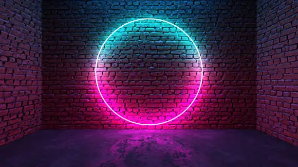 Photo of Circle shaped glowing neon frame on brick wall in dark room