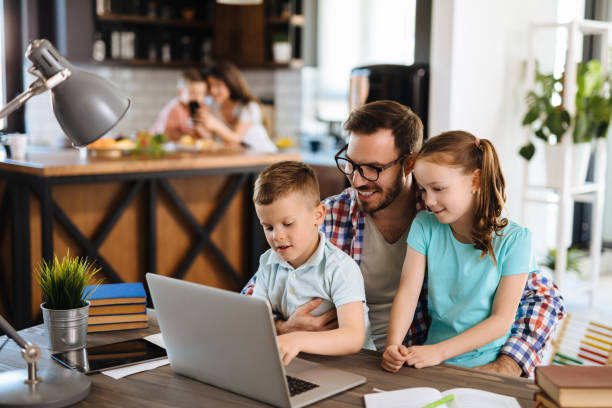 istock Kids having fun at home, playing with their father, using laptop 1178919433