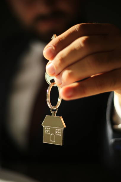 istock Real estate agent giving house keys 1178919477