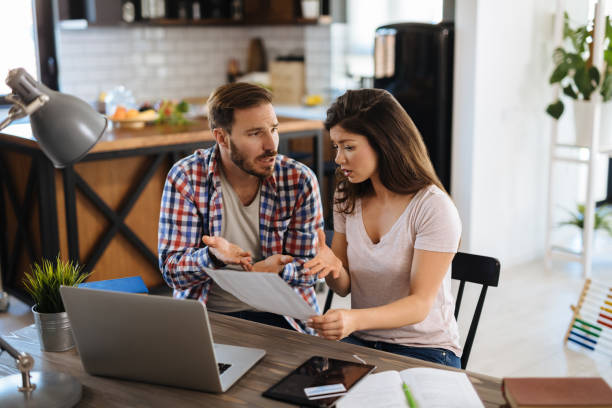 istock Frustrated couple checking bills at home using laptop 1178919697