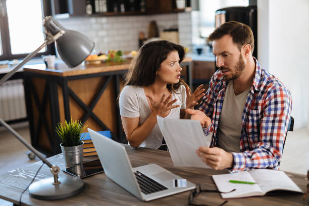 istock Frustrated couple checking bills at home using laptop 1178919783