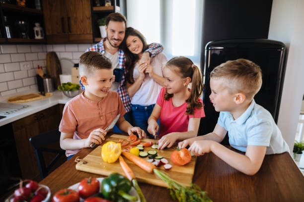 istock Children preparing vegetable salad in the kitchen 1178920016