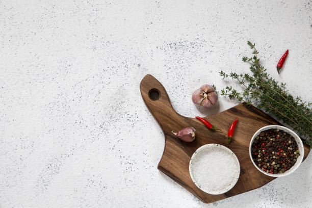 istock Spices, Herbs, Wooden Cutting board for cooking. Cutting board on white concrete backdrop. Top view with copy space for text. Menu, recipe mock up, banner background 1178920959