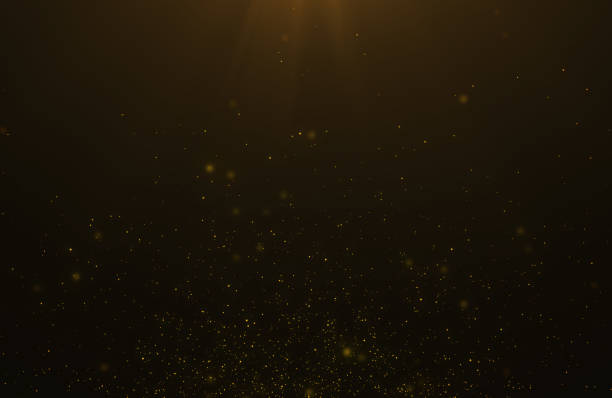 istock Abstract background of flickering gold particles and light flare 1178920964