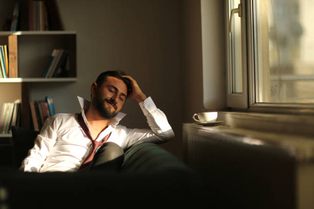 istock Businessman resting on sofa at home 1178921146