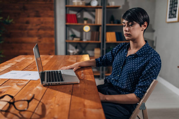 istock Young lady working on laptop in office 1178921324