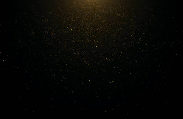 istock Abstract background of flickering gold particles and light flare 1178921537