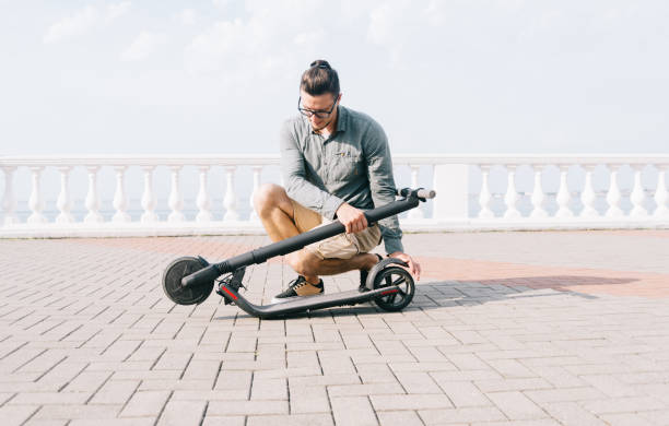 istock Man folding an electric scooter in street. 1178922940
