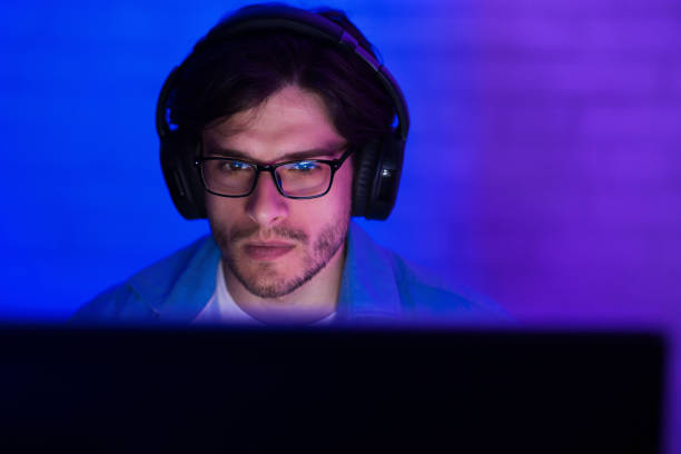 istock Young man in headset playing game at home 1178923873