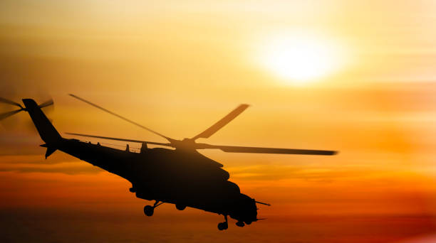 istock Helicopter silhouette flying in the sky at sunset 1178923954