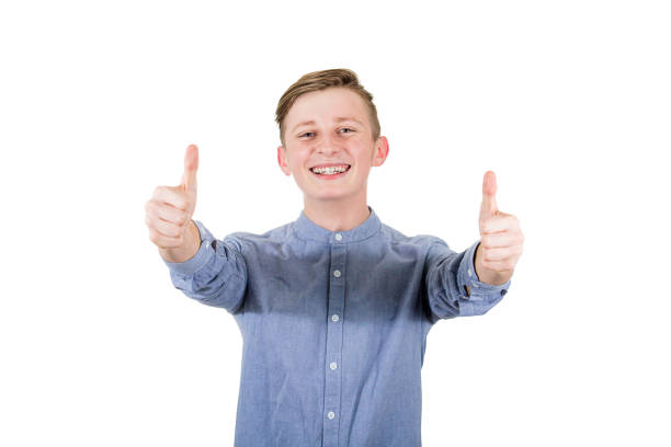 istock Cheerful boy adolescent showing double thumbs up, positive gesture, great feedback and approval, looking to camera with tooth smile isolated over white background 1178924749