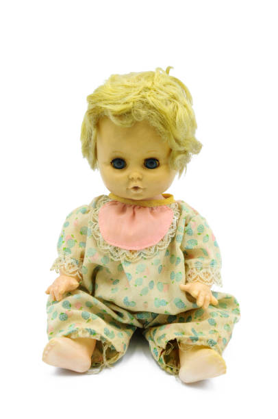 istock Vintage baby doll sitting on white background 1178924912