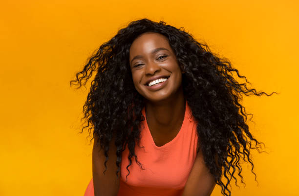 istock Playful black girl having fun over yellow studio background 1178925172