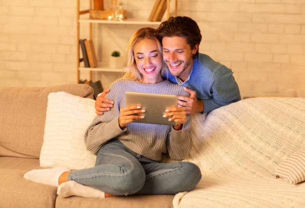 istock Happy Spouses Using Tablet Watching Film At Home 1178925180