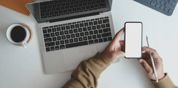 istock Close-up view of young man working on his project while looking for new information on smartphone 1178925402