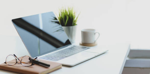 istock Open laptop computer with coffee cup and office supplies in comfortable workplace 1178925426