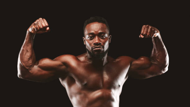 istock Confident bodybuilder demonstrating strong biceps and shoulders 1178925510