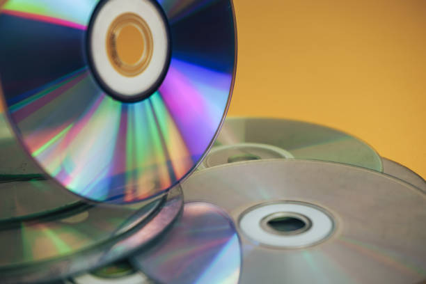 istock Close up Beautiful Old dirty CDs,DVD on yellow background. 1178925530