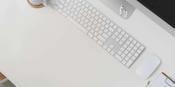 istock Top view of modern workplace with keyboard computer and office supplies on white table background 1178925589